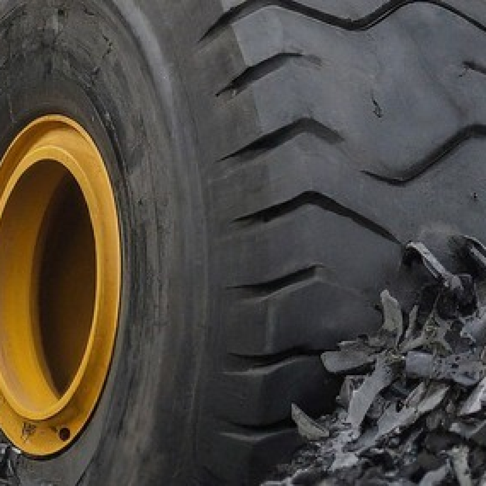 Close-up of a heavy machinery tire on a construction site.